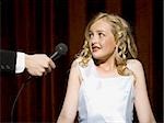 Girl beauty pageant contestant with microphone looking nervous