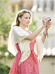 Woman taking a photograph outdoors