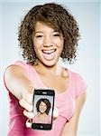 Girl with Braces holding Handheld PDA and Smiling