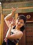 Woman doing tai chi outdoors smiling