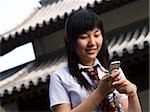 Teenage girl in school uniform smiling with mp3 player