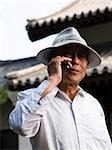 Mature man talking on cell phone outdoors smiling