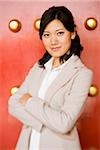 Businesswoman standing with arms crossed smiling