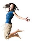 Teenage girl leaping and smiling