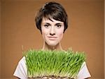 Woman holding grass smiling