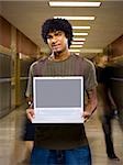 High School boy at school with a notebook computer.