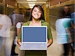 High School girl at school with a notebook computer.
