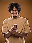 young man in a brown shirt on a cell phone.