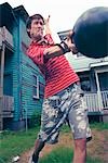 Man in Front Yard Throwing Bowling Ball