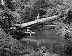 1940s 1950s TWO BOYS WEARING HATS FISHING IN A STREAM