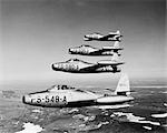 1950s FOUR US AIR FORCE THUNDER JETS IN FLIGHT FORMATION