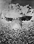 1950s 1960s ATOMIC BOMB SYMBOLIC MONTAGE MUSHROOM CLOUD OVER A VERY LARGE CROWD OF PEOPLE FACING THE EXPLOSION