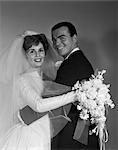 1960s WEDDING BRIDE AND GROOM PORTRAIT LOOKING AT CAMERA