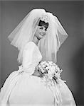 1960s BRIDE PORTRAIT IN WEDDING DRESS VEIL BRIDAL BOUQUET