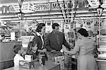 1950s FAMILY AT GROCERY CHECK OUT COUNTER