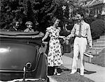 1930s FAMILY OF FOUR GETTING INTO CONVERTIBLE WITH PICNIC BASKET AND THERMOS JUG