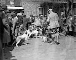 1920s 1930s HUNTING DOGS AND OWNERS ASSEMBLED FOR FIELD TRIALS IN FRONT OF BRICK BUILDING