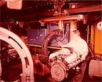 1960s MOTOR FACTORY ASSEMBLY LINE WORKER ADJUSTING ENGINE