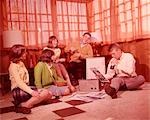 1960s GROUP OF TEENS PLAYING RECORDS