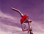 1960s NOZZLE HANDLE OF GASOLINE PUMP WITH BLUE SKY BACKGROUND