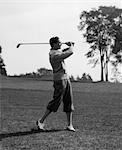 1930s GOLFER IN KNICKERS WITH CLUB IN AIR