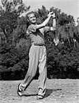 1930s MALE GOLFER SWINGING CLUB