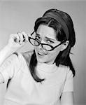 1960s WOMAN BRUNETTE LONG HAIR REMOVE PUT ON EYE GLASSES DISBELIEF QUESTION FUNNY FACE EXPRESSION