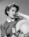 1950s FRUSTRATED TIRED ANGRY WOMAN HOLDING PLATE AND DISH TOWEL
