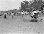 HOMME MONTÉ SUR UN TAUREAU DANS UN RANCH