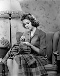 1940s YOUNG WOMAN TEEN SITTING IN CHAIR UNDER LAMP SEWING