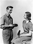 1940s TEEN COUPLE BOY GIRL TALKING SMILING HOLDING PING PONG TABLE TENNIS PADDLES