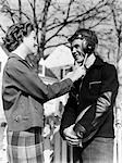 1940s CUTE ROMANTIC TEEN COUPLE GIRL HOLDING STRAPS OF BOYS FOOTBALL HELMET