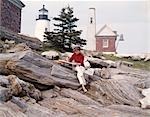 1960s 1970s RETRO ARTIST PAINTER WOMAN PAINTING NEW HARBOR PEMAQUID MAINE LIGHTHOUSE AND ROCK FORMATIONS