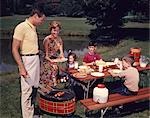 1960s FAMILY FATHER MOTHER TWO SONS DAUGHTER ENJOYING OUTDOOR BAR-B-CUE