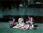 1950s FAMILY PICNIC BY POND LAKE MOM DAD BOY GIRL WILLOW TREE TABLECLOTH SPREAD COOLER THERMOS BASKET FOOD SUMMER MEAL