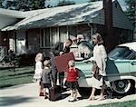 1950s 1960s SUBURBAN FAMILY LOADING FORD FOUR DOOR SEDAN AUTOMOBILE FOR VACATION TRIP