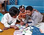 1960s AFRICAN AMERICAN FAMILY OF 3 MOM DAD DAUGHTER TOGETHER LOOK AT PAINT CHIPS BLUEPRINTS COLOR SAMPLES NEW HOME