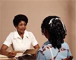 1970s AFRICAN AMERICAN ADULT WOMAN INTERVIEWING TEENAGE GIRL