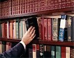 1960s MAN HAND REACHING BIBLE LIBRARY BOOKSHELF