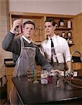 1960s TWO MALE COLLEGE STUDENTS IN SCIENCE LAB