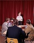 1960s SIX TEEN STUDENTS SIT AROUND CONFERENCE TABLE