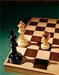 THREE CHESS PIECES KING QUEEN ROOK ON CHESSBOARD CHECKMATE GAME STRATEGY