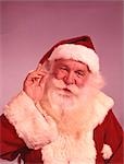 ANNÉES 1960 PORTRAIT SOURIANT SANTA CLAUS HOLDING UP MAIN