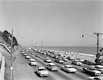 1950s 1960s HIGHWAY TRAFFIC CARS ALONG MALIBU BEACH SANTA MONICA CALIFORNIA USA TRANSPORTATION