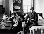 1890s PAIR OF MALE STUDENTS STUDYING IN DORM ROOM