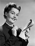 1950s SMILING WOMAN BUSINESS SECRETARY TAKING NOTES WITH PENCIL ON PAD