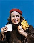 1940s 1950a SMILING COLLEGE GIRL WEARING FUR COAT HOMECOMING MUM HOLDING CUP AND HOT DOG