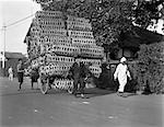 1920s 1930s MAN PULLING CART PILED HIGH WITH WICKER BASKETS
