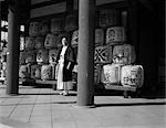 HOMME JAPONAIS DES ANNÉES 1920, DES ANNÉES 1930 EN ROBES PRÊTRE DEBOUT AU MILIEU DE SACRÉ SAKÉ RIZ FÛTS DE VIN AT HEIAN SHRINE JAPON