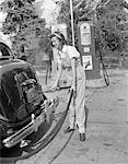 1940s WOMAN GAS STATION ATTENDANT FILLING CAR TANK